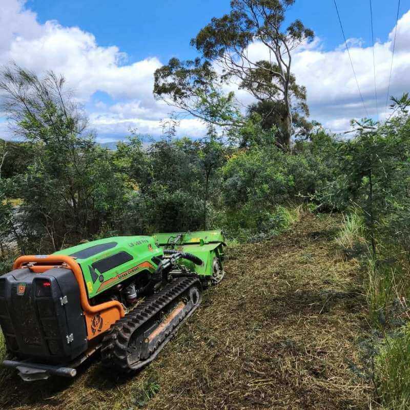 machine cutting shrubs and grass
